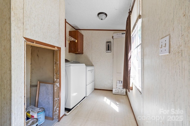 3317 Treyburn Dr, Midland, NC 28107 - laundry area featuring cabinet space, ornamental molding, wallpapered walls, light floors, and washing machine and dryer