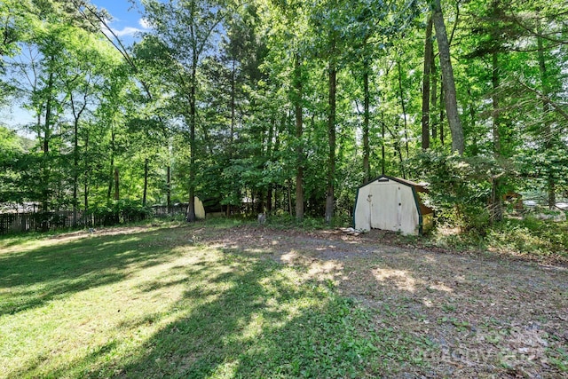3317 Treyburn Dr, Midland, NC 28107 - view of yard with fence, a storage unit, and an outbuilding