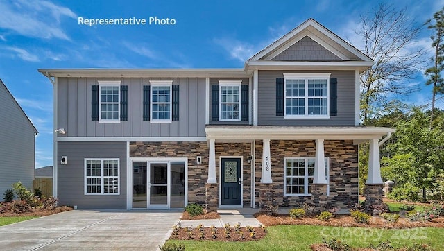 craftsman-style home with covered porch, board and batten siding, and stone siding