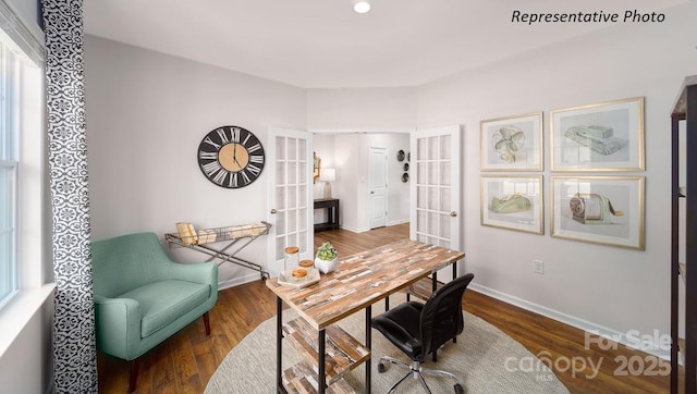 office space with wood finished floors, french doors, and baseboards