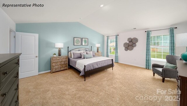 bedroom featuring lofted ceiling, light colored carpet, visible vents, and baseboards