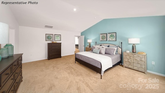 bedroom with baseboards, visible vents, light carpet, and lofted ceiling