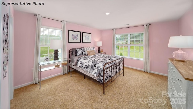 bedroom with baseboards, recessed lighting, and light carpet