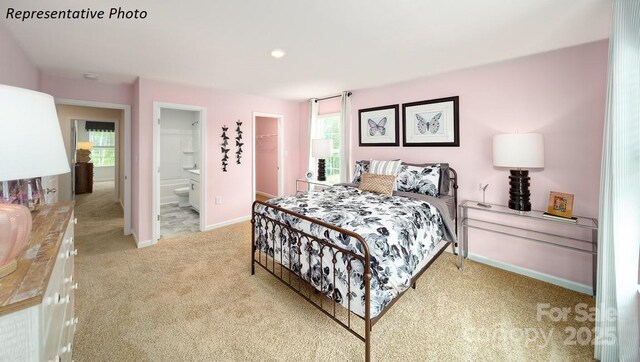 carpeted bedroom with recessed lighting, a closet, ensuite bath, baseboards, and a spacious closet