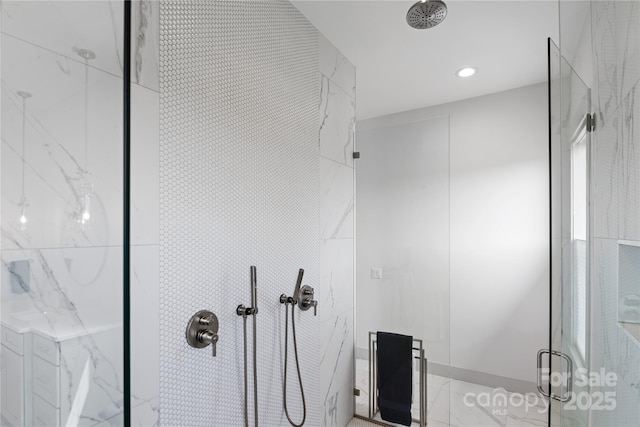 bathroom featuring a marble finish shower