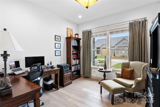 office featuring recessed lighting, baseboards, and light wood finished floors