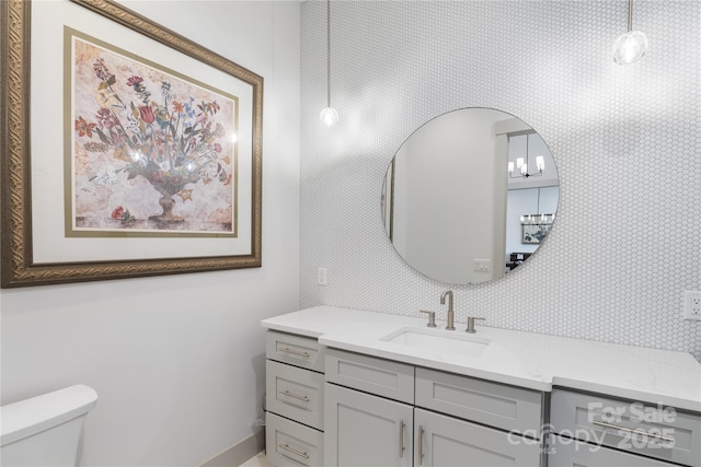 bathroom featuring toilet and vanity