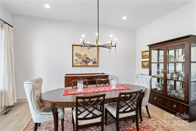 dining area with visible vents, light wood-type flooring, baseboards, an inviting chandelier, and recessed lighting
