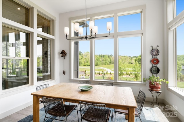 sunroom / solarium with an inviting chandelier