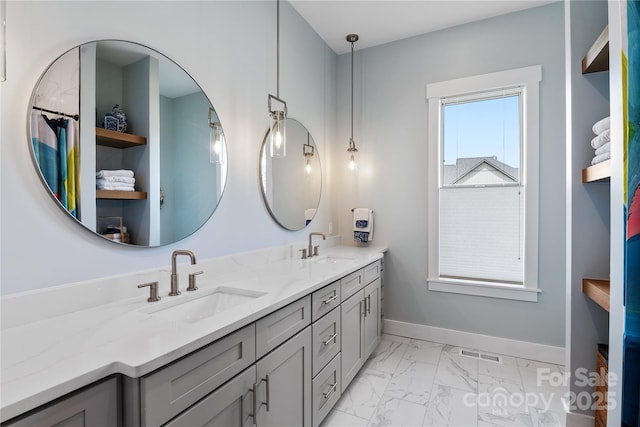 bathroom featuring double vanity, visible vents, a sink, and marble finish floor