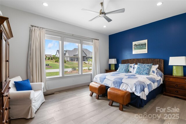 bedroom with ceiling fan, visible vents, light wood-type flooring, baseboards, and recessed lighting