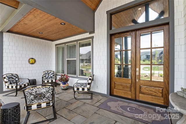 property entrance featuring french doors and a patio