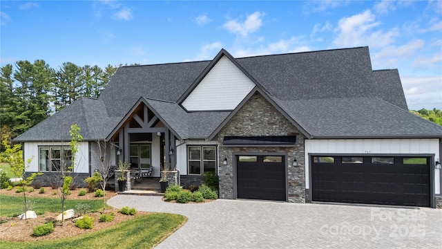 view of front of house featuring stone siding, a garage, board and batten siding, decorative driveway, and covered porch