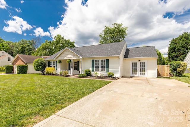 ranch-style house with covered porch, roof with shingles, french doors, and a front lawn