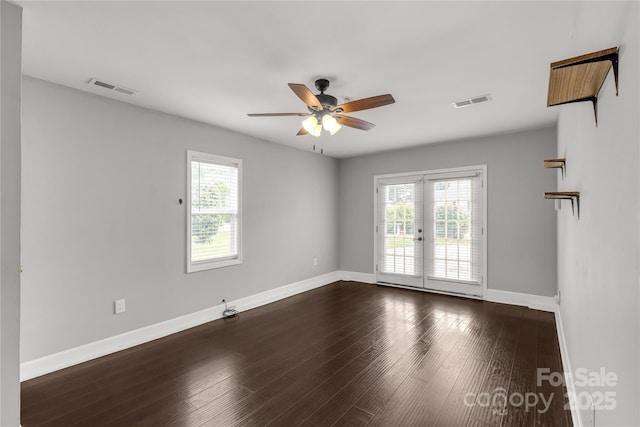 empty room featuring visible vents, baseboards, a ceiling fan, and a healthy amount of sunlight