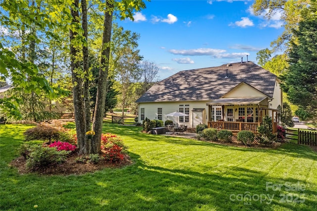 back of property featuring a lawn, a deck, a patio, and fence
