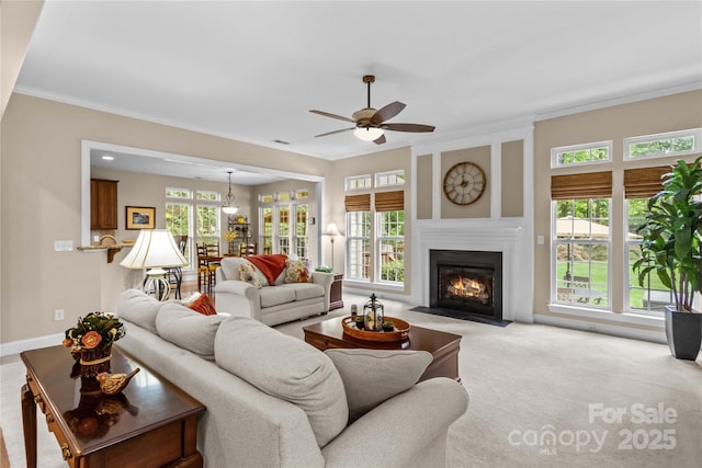 living room with a fireplace with flush hearth, light carpet, a ceiling fan, and ornamental molding