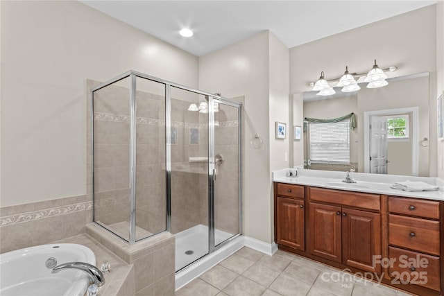 full bathroom with tile patterned floors, vanity, a shower stall, and a garden tub