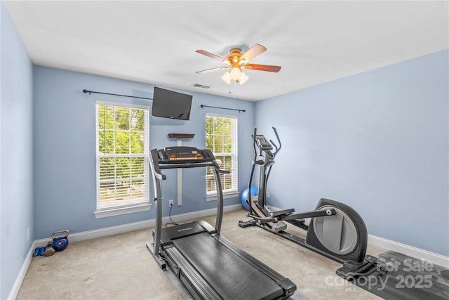 exercise room with ceiling fan, carpet flooring, baseboards, and visible vents