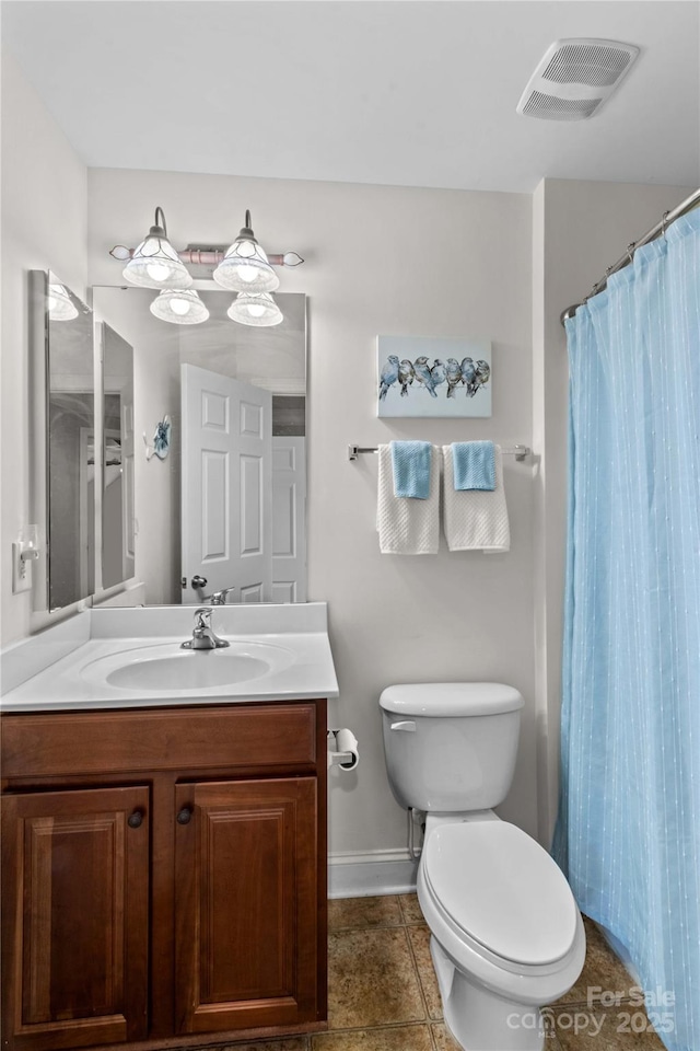bathroom with baseboards, toilet, visible vents, tile patterned floors, and vanity