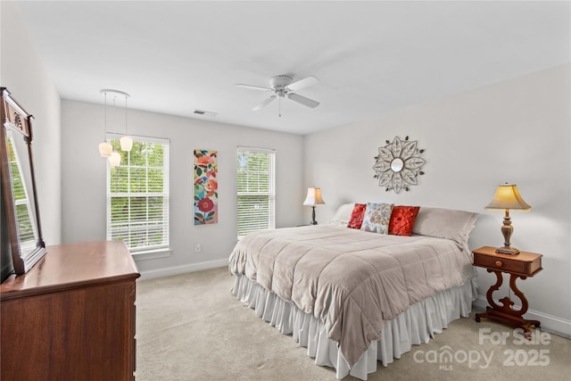 bedroom featuring baseboards, ceiling fan, light carpet, and visible vents