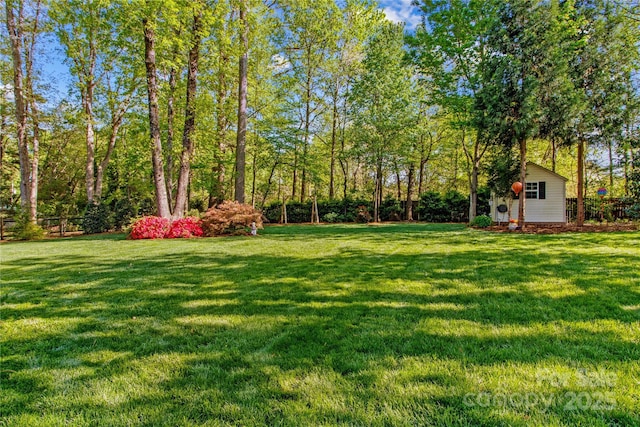 view of yard with an outbuilding and fence