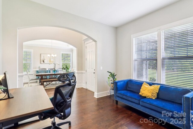 1004 Princesa Dr, Matthews, NC 28104 - office with arched walkways, wood finished floors, a chandelier, and wainscoting