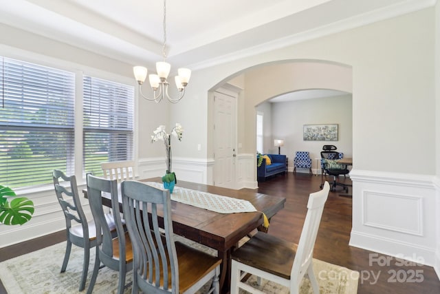 1004 Princesa Dr, Matthews, NC 28104 - dining room featuring an inviting chandelier, arched walkways, wood finished floors, and a wainscoted wall