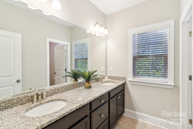1004 Princesa Dr, Matthews, NC 28104 - bathroom featuring tile patterned floors, plenty of natural light, and a sink