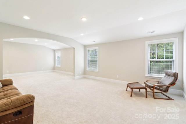 1004 Princesa Dr, Matthews, NC 28104 - living area featuring arched walkways, visible vents, light carpet, and recessed lighting