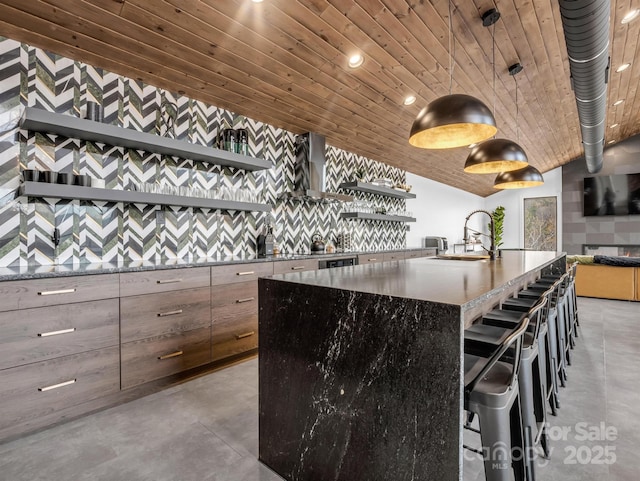 interior space featuring wood ceiling, concrete flooring, a sink, lofted ceiling, and wall chimney exhaust hood