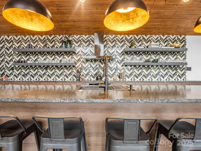 kitchen featuring wooden ceiling and a sink