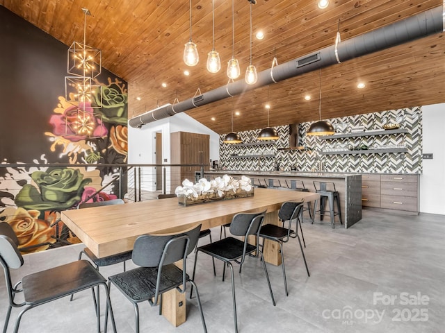 dining room featuring finished concrete flooring, high vaulted ceiling, wood ceiling, and visible vents
