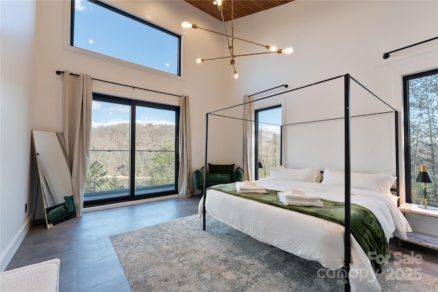 bedroom featuring a high ceiling, multiple windows, and wood ceiling