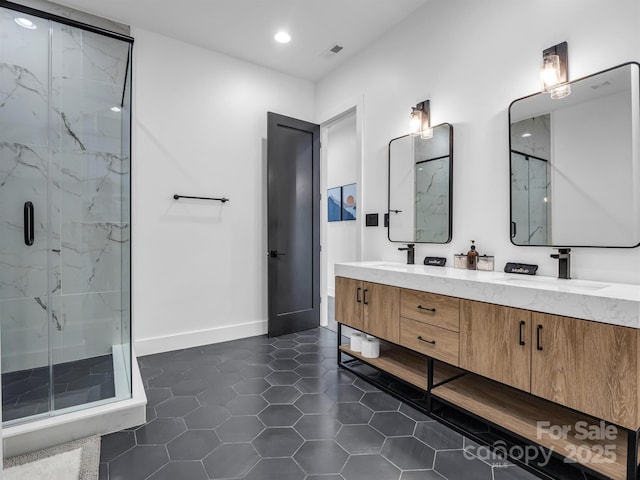 full bathroom featuring a sink, tile patterned flooring, double vanity, a marble finish shower, and recessed lighting
