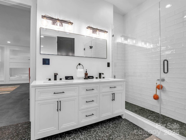 bathroom featuring double vanity, recessed lighting, a sink, and a stall shower