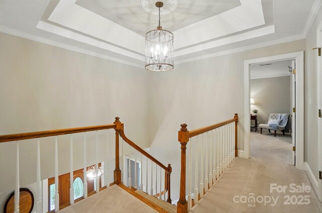 3804 Bellingham Ln, Charlotte, NC 28215 - staircase featuring a raised ceiling, a chandelier, crown molding, and carpet flooring
