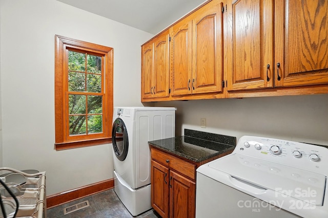 3804 Bellingham Ln, Charlotte, NC 28215 - laundry area featuring cabinet space, baseboards, and washing machine and clothes dryer