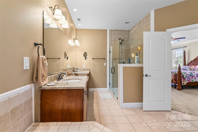ensuite bathroom featuring tile patterned flooring, ensuite bath, visible vents, and a shower stall