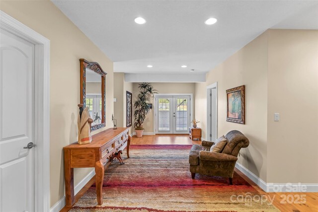 interior space with french doors, recessed lighting, and wood finished floors