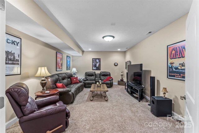 living area featuring carpet floors, baseboards, and visible vents