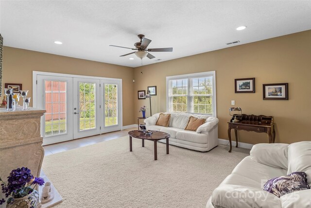 living area featuring visible vents, plenty of natural light, ceiling fan, and french doors