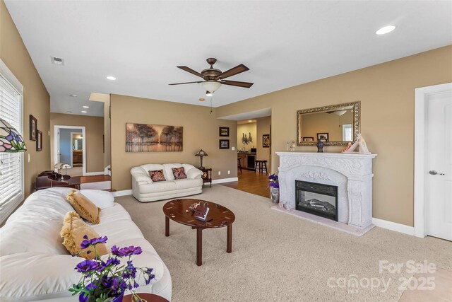 carpeted living area featuring visible vents, recessed lighting, baseboards, and ceiling fan