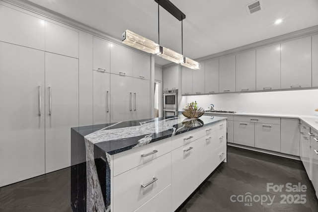 1550 High St, Charlotte, NC 28211 - kitchen featuring visible vents, double oven, a center island, dark stone counters, and hanging light fixtures