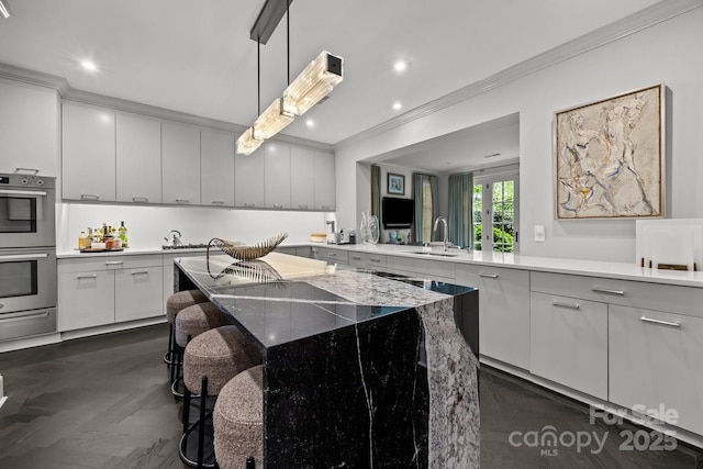 1550 High St, Charlotte, NC 28211 - kitchen featuring stainless steel double oven, crown molding, hanging light fixtures, a sink, and a warming drawer