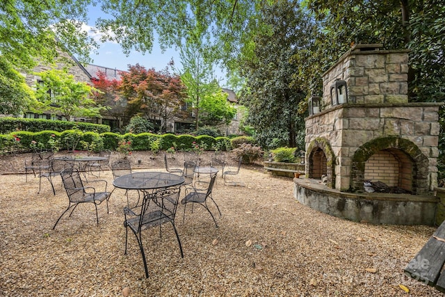 1550 High St, Charlotte, NC 28211 - view of yard featuring an outdoor stone fireplace and a patio area