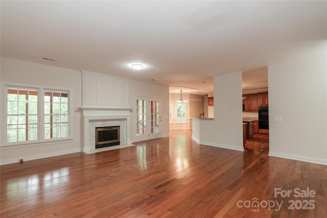 4410 Laurel Twig Ct, Charlotte, NC 28215 - unfurnished living room featuring visible vents, baseboards, wood finished floors, and a fireplace