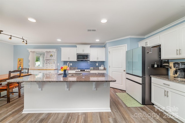 2886 Sherrills Stream Dr, Sherrills Ford, NC 28673 - kitchen with a sink, visible vents, ornamental molding, white cabinets, and appliances with stainless steel finishes