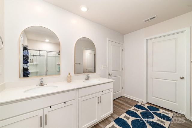2886 Sherrills Stream Dr, Sherrills Ford, NC 28673 - full bath featuring double vanity, wood finished floors, visible vents, and a sink