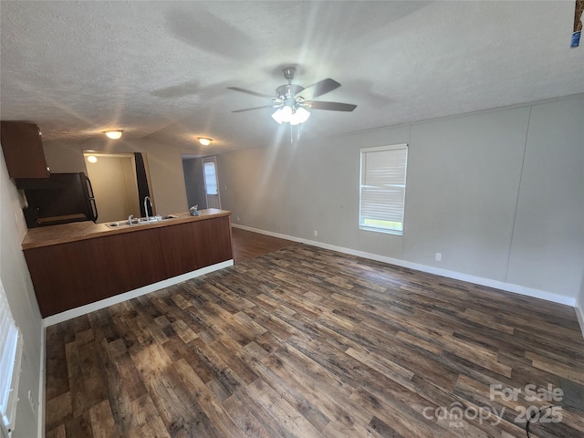 544 Bentley Rd, Shelby, NC 28152 - unfurnished living room featuring a sink, a ceiling fan, dark wood-style floors, and a textured ceiling